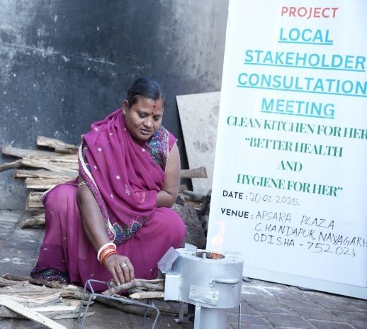 A cookstove demonstration beside a banner for a local stakeholder consultation in Nayagarh, Odisha, on 20 January 2025